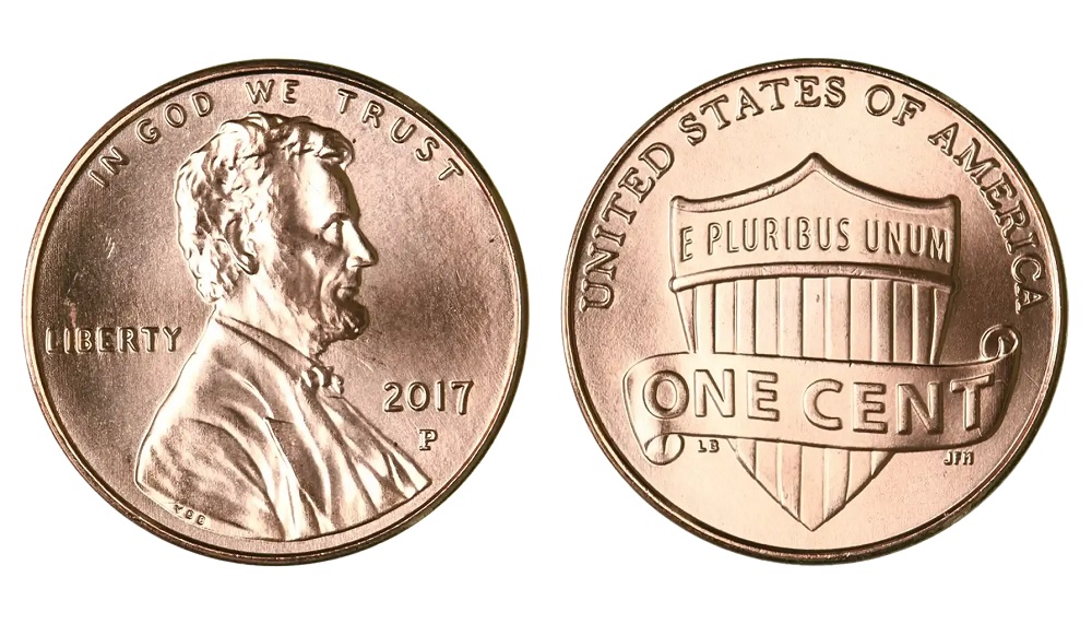 Side-by-side comparison of 2017-P penny showing the historic first P mint mark versus a common cent without a mint mark, with annotation of the P position below the date
