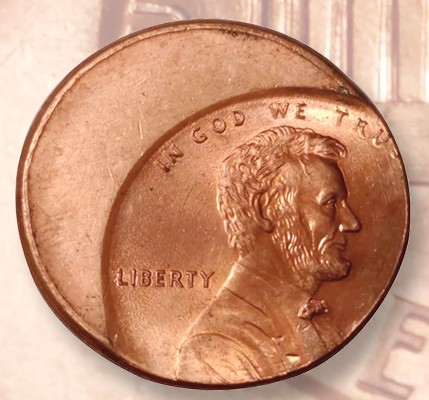 2017 Lincoln penny off-center strike error showing approximately 40% off-center with full date visible and crescent of blank planchet
